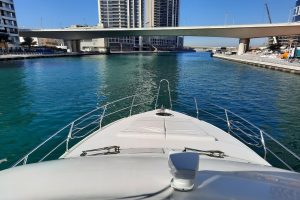 View from the top deck of a luxury yacht in Dubai Marina showing a sunbed and open blue sea by MTS Yachts Dubai