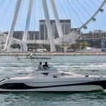 Tourist boat near Ain Dubai, showcasing the giant Ferris wheel and modern Dubai architecture.