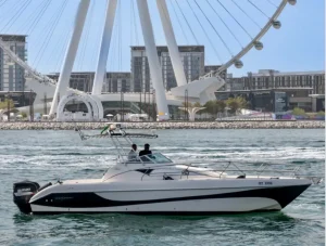 Tourist boat near Ain Dubai, showcasing the giant Ferris wheel and modern Dubai architecture.