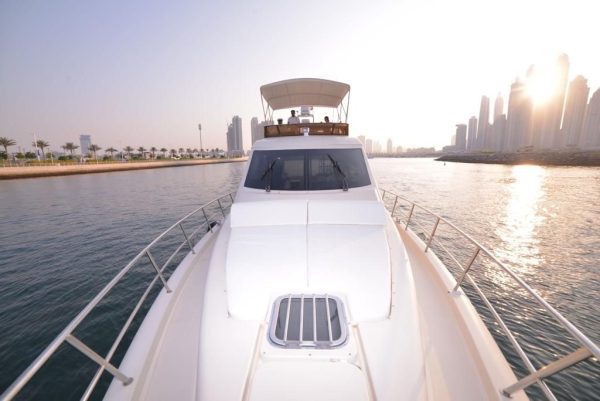 View from yacht front showing captain area and sunset during sunset yacht cruise Dubai Marina with MTS Yachts