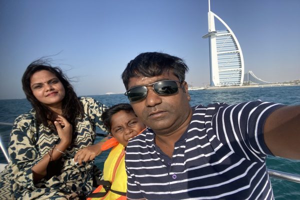 A family capturing a selfie with the Burj Al Arab in the background, enjoying a 2-hour MTS Yachts boat trip in Dubai.